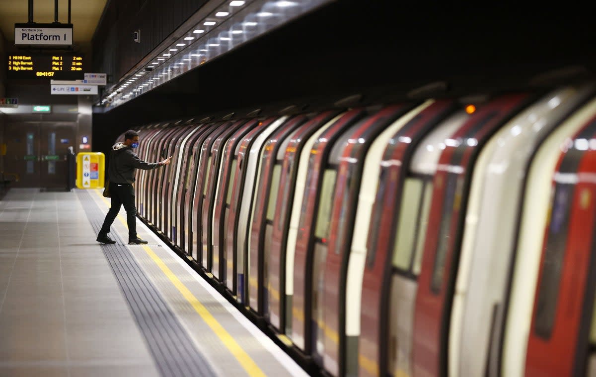 A passenger boards a Tube train at Battersea Power station, which opened in 2021 (AFP via Getty Images)