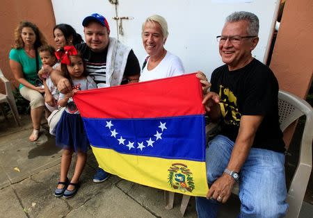 Venezuelans living in Nicaragua hold up a Venezuelan flag after casting their vote during an unofficial plebiscite against Venezuela's President Nicolas Maduro's government in Managua, Nicaragua July 16,2017.REUTERS/Oswaldo Rivas