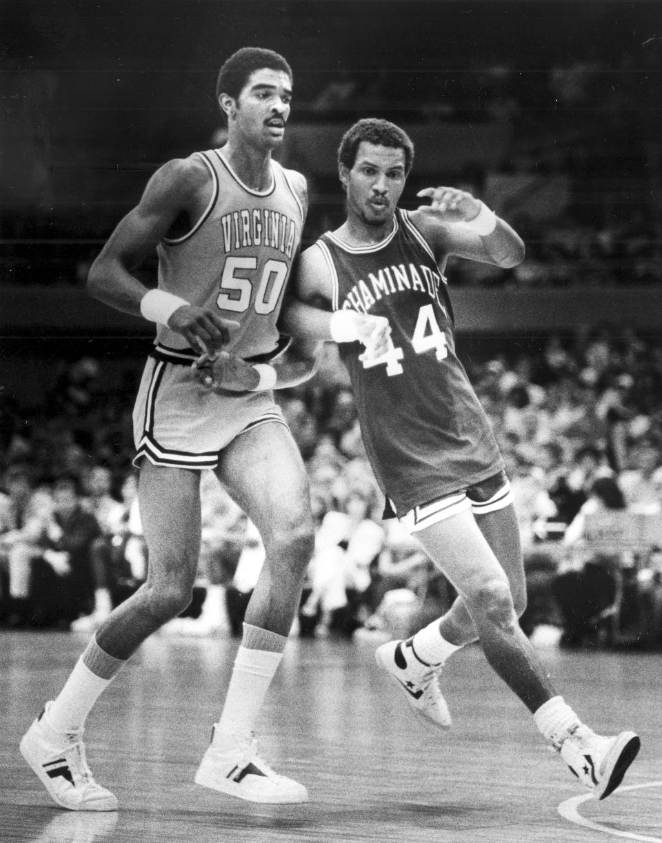 FILE - Chaminade's Tony Randolph, right, moves around Virginia's Ralph Sampson during an NCAA college basketball game in Honolulu, Dec. 23, 1982. Chaminade defeated No. 1 ranked Virginia 77-72. (AP Photo/File)