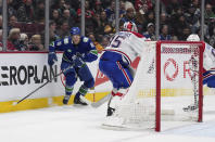 Vancouver Canucks' Jack Studnicka (18) knocks down Montreal Canadiens goalie Sam Montembeault's clearing pass and takes the puck around the net to score during the third period of an NHL hockey game in Vancouver, British Columbia, Monday, Dec. 5, 2022. (Darryl Dyck/The Canadian Press via AP)