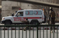 <p>A security personnel points his pistol on a suspected ambulance driver at the site of a deadly suicide attack in the center of Kabul, Afghanistan, Saturday, Jan. 27, 2018. (Photo: Massoud Hossaini/AP) </p>