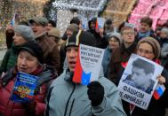 Opposition supporters hold a copies of Russia's constitution during a rally against constitutional reforms proposed by President Vladimir Putin, in Moscow