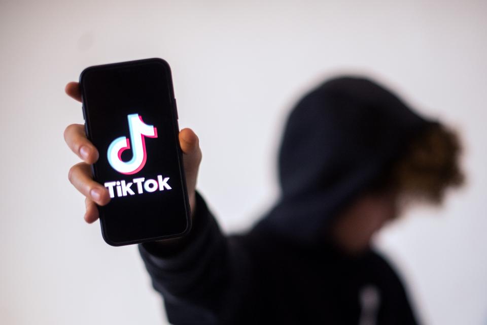 <p>File image: A teenager presents a smartphone with the logo of Chinese social network Tik Tok</p> (Getty Images)