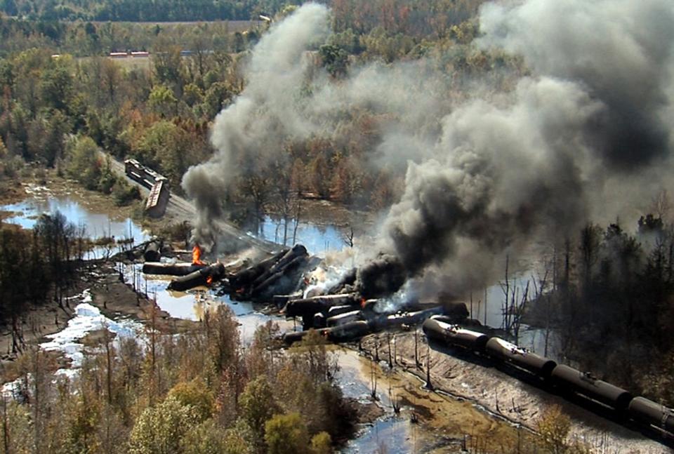 Smoke rises from a number of cars that derailed and exploded from a train carrying crude oil in Aliceville