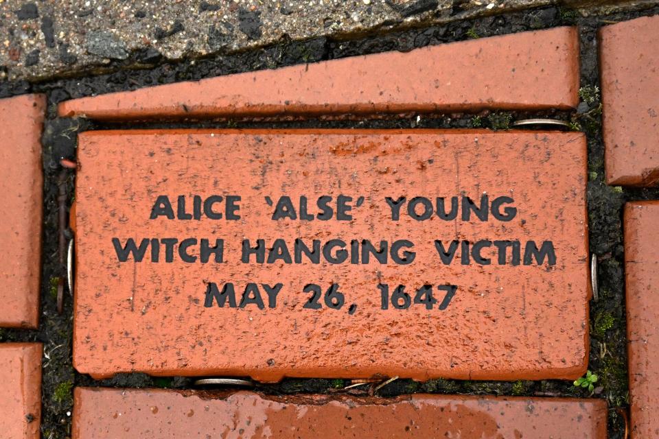 In this Tuesday, Jan. 24, 2023 photo, a brick memorializing Alice 'Alse' Young is placed in a town Heritage Bricks installation in Windsor, Conn. Young was the first person on record to be executed in the 13 colonies for witchcraft. Now, more than 375 years later, amateur historians, researchers and descendants of the accused witches and their accusers, from across the U.S., are urging Connecticut officials to officially acknowledge this dark period of the state's colonial history and posthumously exonerate those wrongfully accused and punished.