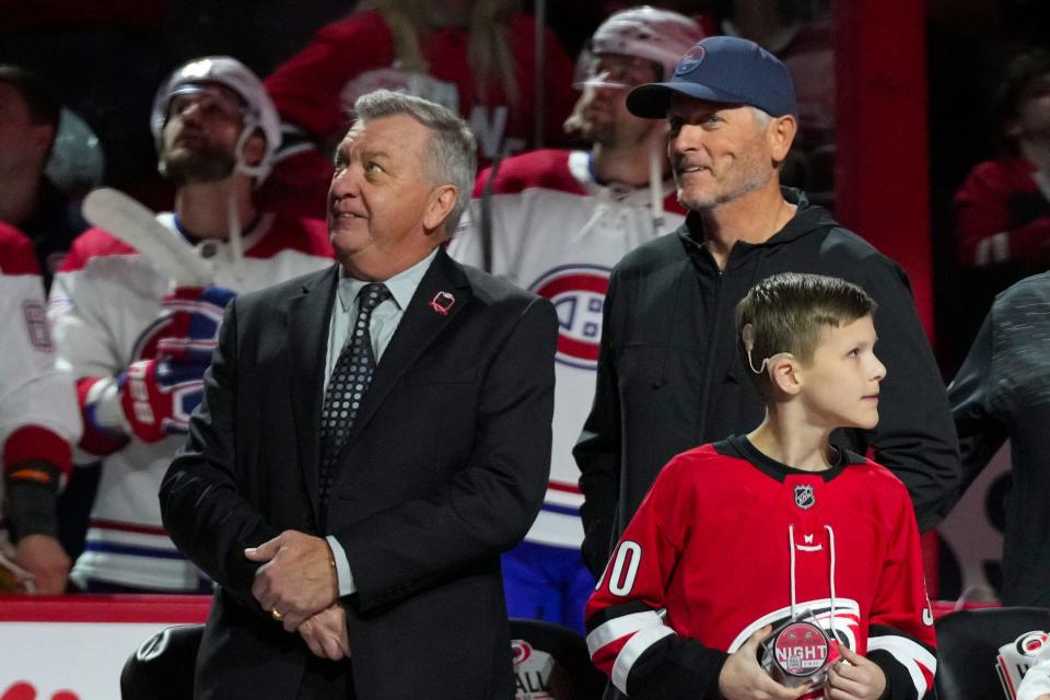 Feb 16, 2023; Raleigh, North Carolina, USA; Carolina Hurricanes GM Don Waddell and Hurricanes owner Tom Dundon look on during the retirement of Cam Ward jersey before the game against the Montreal Canadiens at PNC Arena. Mandatory Credit: James Guillory-USA TODAY Sports