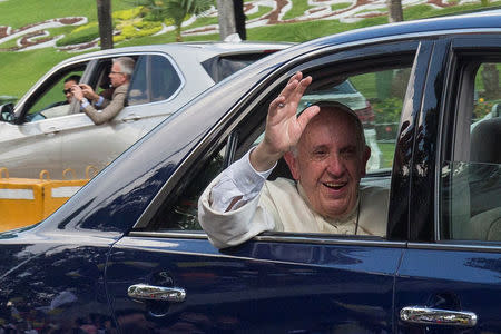 Pope Francis's waves from his car after arriving in Yangon, Myanmar November 27, 2017. REUTERS/Stringer NO SALES NO ARCHIVES