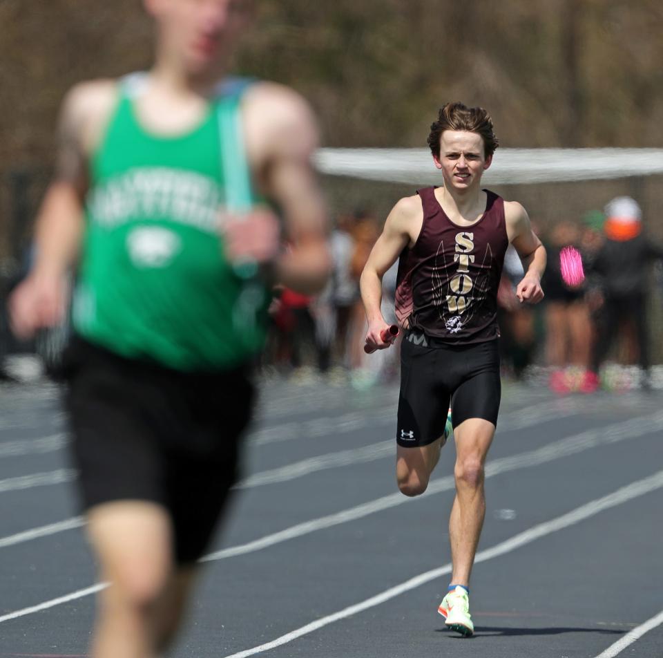 Stow's Zachary Shawala nearly laps a runner from Mayfield as he wins the distance medley relay Saturday at the Nordonia Knight Relays.