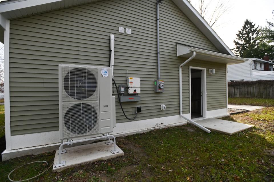 A solar inverter on the south side of the new Ingham County Land Bank home on Avalon Street in Lansing, pictured Wednesday, Nov. 15, 2023. The two-bedroom, one-bathroom, solar-sustainable home features energy-efficient appliances.