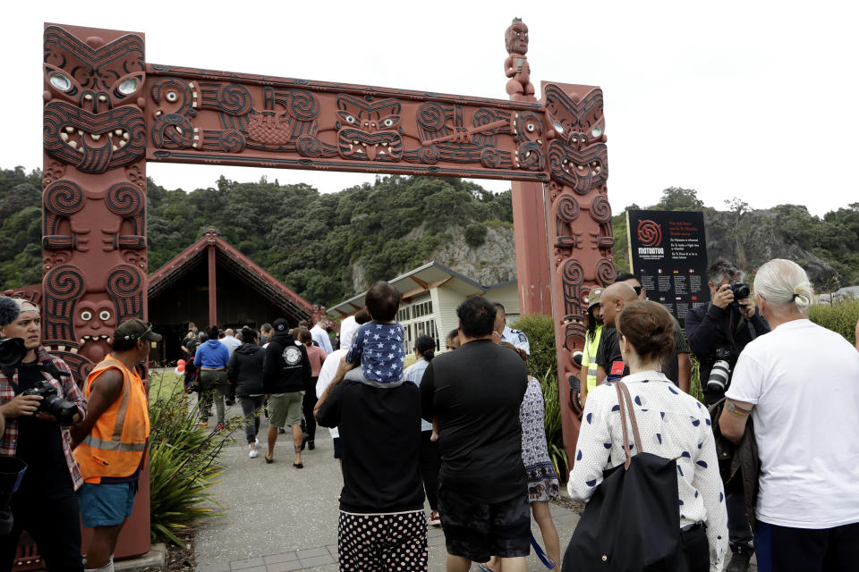 Families of victims of the White Island eruption walkminto a nearby marae following a blessing at sea ahead of the recovery operation off the coast of Whakatane New Zealand, Friday, Dec. 13, 2019. A team of eight New Zealand military specialists landed on White Island early Friday to retrieve the bodies of victims after the Dec. 9 eruption. (AP Photo/Mark Baker)