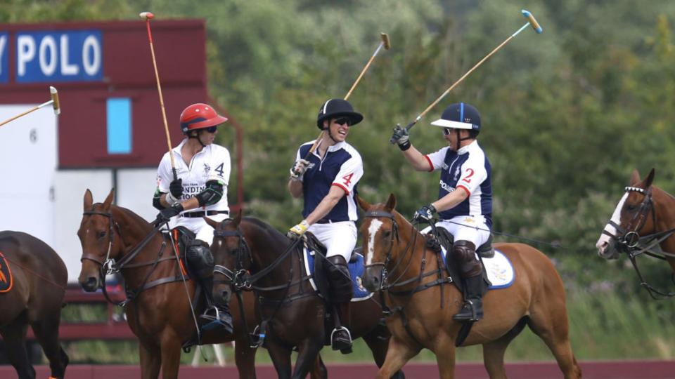 Prince William, Prince of Wales (C) and Aiyawatt Srivaddhanaprabha, (R) Chairman of Leicester City Football Club, share a joke as they take part in the Out-Sourcing Inc. Royal Charity Polo Cup 2023