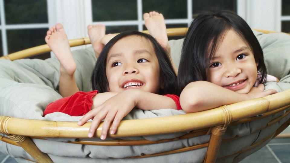 Girls Lying in Papasan Chair