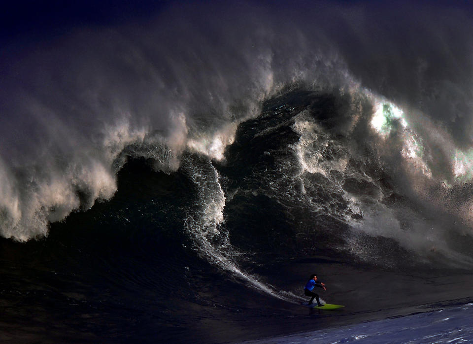 A surfer rides a large wave at El Bocal