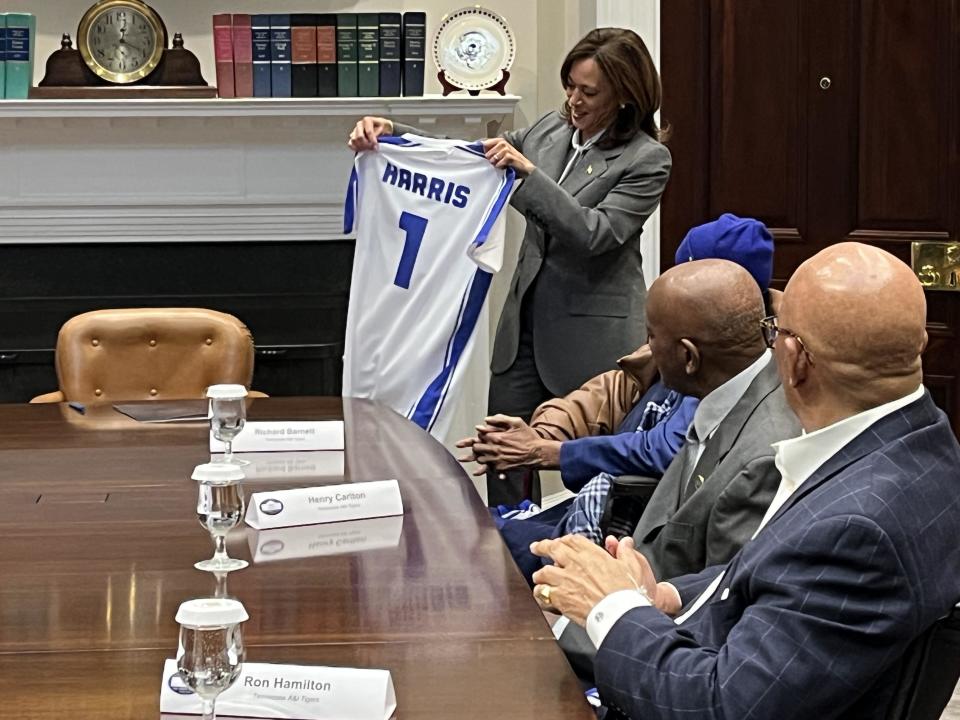 Vice President Kamala Harris holds up a customized jersey presented to her by members of the Tennessee A&I championship teams. / Credit: Willie James Inman/CBS News