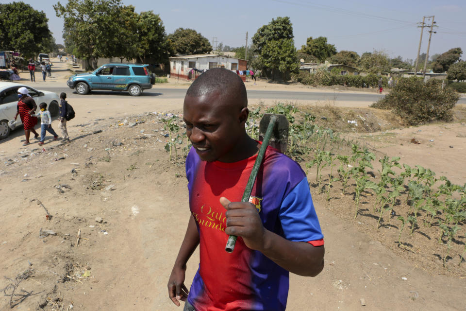 Tinashe Mapuranga works outside his home near Harare, Zimbabwe, on Thursday, Aug, 25, 2021. Amid the lockdowns from the coronavirus pandemic, the 24-year-old was one of the first to be laid off from his job as an intern at a leading bank and has no idea when he'll be able to get his degree because of frequent school closures. "It has really affected me a lot in my studies. I have no money to buy data and I don't have a personal laptop to study online and keep up like what others are doing," said Mapuranga. A survey of people aged 18-24 in 15 African countries found that many have lost jobs or have seen their education disrupted by the pandemic. (AP Photo/Tsvangirayi Mukwazhi)