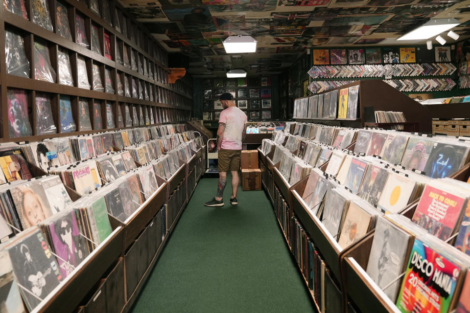 Jeff Maimon, of Chicago, checks out some vinyl at Tracks In Wax record shop, Thursday, April 18, 2024, in Phoenix. Special LP releases, live performances and at least one giant block party are scheduled around the U.S. Saturday as hundreds of shops celebrate Record Store Day amid a surge of interest in vinyl and the day after the release of Taylor Swift's latest album. (AP Photo/Ross D. Franklin)