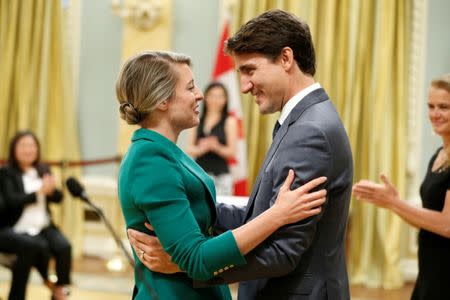 Canada's Prime Minister Justin Trudeau congratulates Melanie Joly after she was sworn-in as Minister of Tourism, Official Languages and La Francophonie during a cabinet shuffle at Rideau Hall in Ottawa, Ontario, Canada, July 18, 2018. REUTERS/Chris Wattie