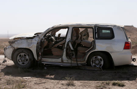 An armored car damaged by a bomb, which Peshmerga sources say was driven by media, is seen in Targella village near Khaser, east of Mosul. REUTERS/Azad Lashkari