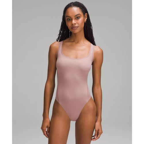 model wearing pink bodysuit