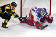 New York Rangers goaltender Keith Kinkaid (71) pounces on the puck as he makes a save against Boston Bruins center Brad Marchand (63) without his stick during the second period of an NHL hockey game, Saturday, May 8, 2021, in Boston. (AP Photo/Charles Krupa)