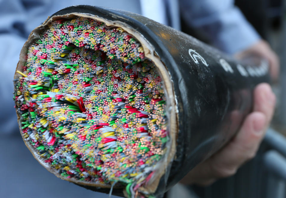 A phone cable in a cable shaft in Berlin is being shown during a press conference in Berlin, Germany, 06 October 2014. To prevent the theft of copper, the Telecom marks the underground cables with a so-called artificial DNA, a luminescent liquid, that can only be detected with a UV flash. When touched, the liquid can transfer onto people. PHOTO: STEPHANIE PILICK/DPA | usage worldwide   (Photo by Stephanie Pilick/picture alliance via Getty Images)