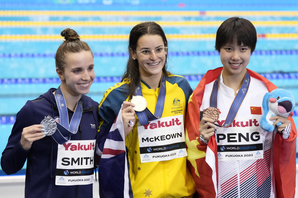 Medalists, from left to right, Regan Smith of the U.S., silver, Kaylee McKeown of Australia, gold, and Peng Xuwei of China, bronze celebrate during the medal ceremony for women's 200m backstroke final at the World Swimming Championships in Fukuoka, Japan, Saturday, July 29, 2023. (AP Photo/Lee Jin-man)