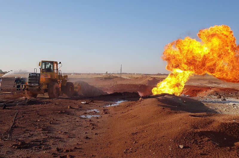 A view of fire from an explosion on the Arab Gas Pipeline is seen between the towns of Ad Dumayr and Adra, northwest of the capital of Damascus