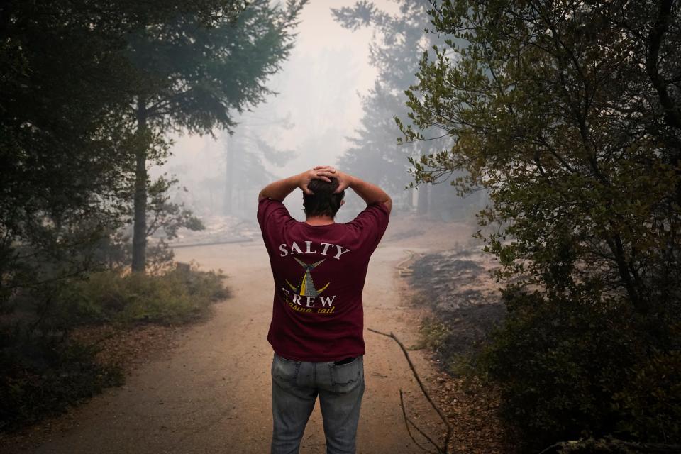 Peter Koleckar reacts after seeing multiple home burned in his neighborhood after the CZU August Lightning Complex Fire passed through on Thursday, Aug. 20, 2020, in Bonny Doon, Calif.