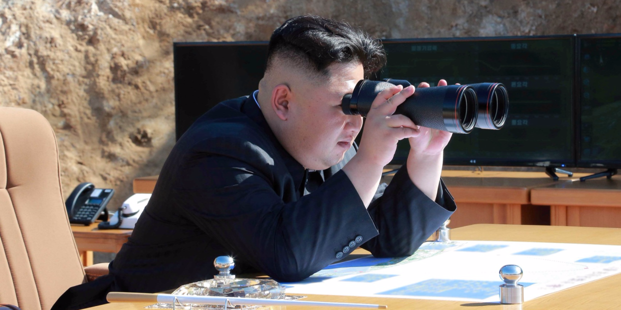 kim yong un binoculars looking icbm intercontinental ballistic missile north korea hwasong 14 RTX39YHL