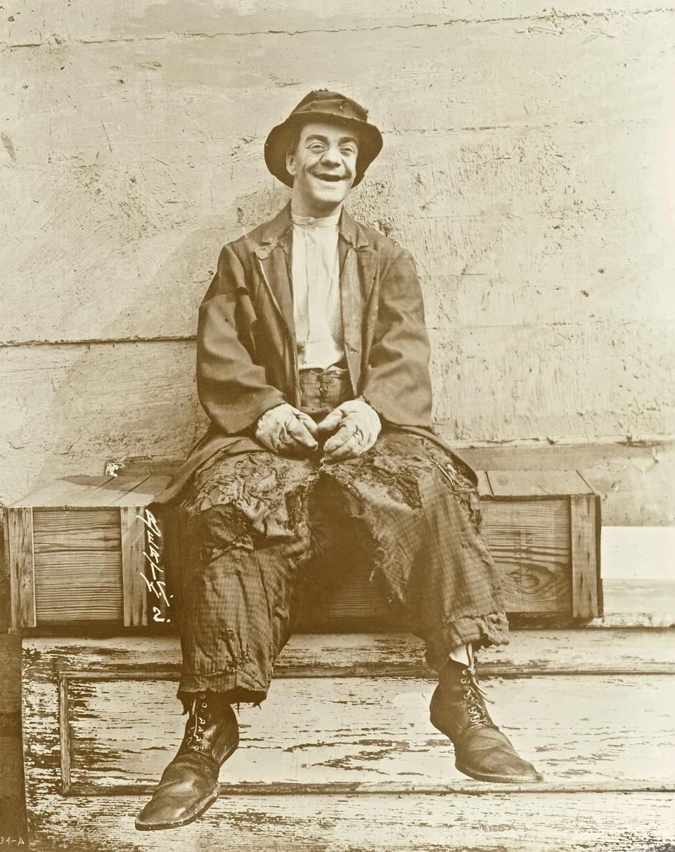 Tommy "Bozo" Snyder perches on a box, clad in his tramp clown duds — including the enormous shoes now in possession of the Washington County Historical Society.