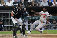 Baltimore Orioles shortstop Jorge Mateo, right, scores on a single by Richie Martin as Chicago White Sox catcher Reese McGuire waits for the throw during the second inning of a baseball game in Chicago, Friday, June 24, 2022. (AP Photo/Nam Y. Huh)