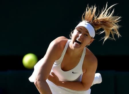 FILE PHOTO - Maria Sharapova of Russia serves during her match against Serena Williams of the U.S.A. at the Wimbledon Tennis Championships in London, July 9, 2015. REUTERS/Toby Melville/File Photo