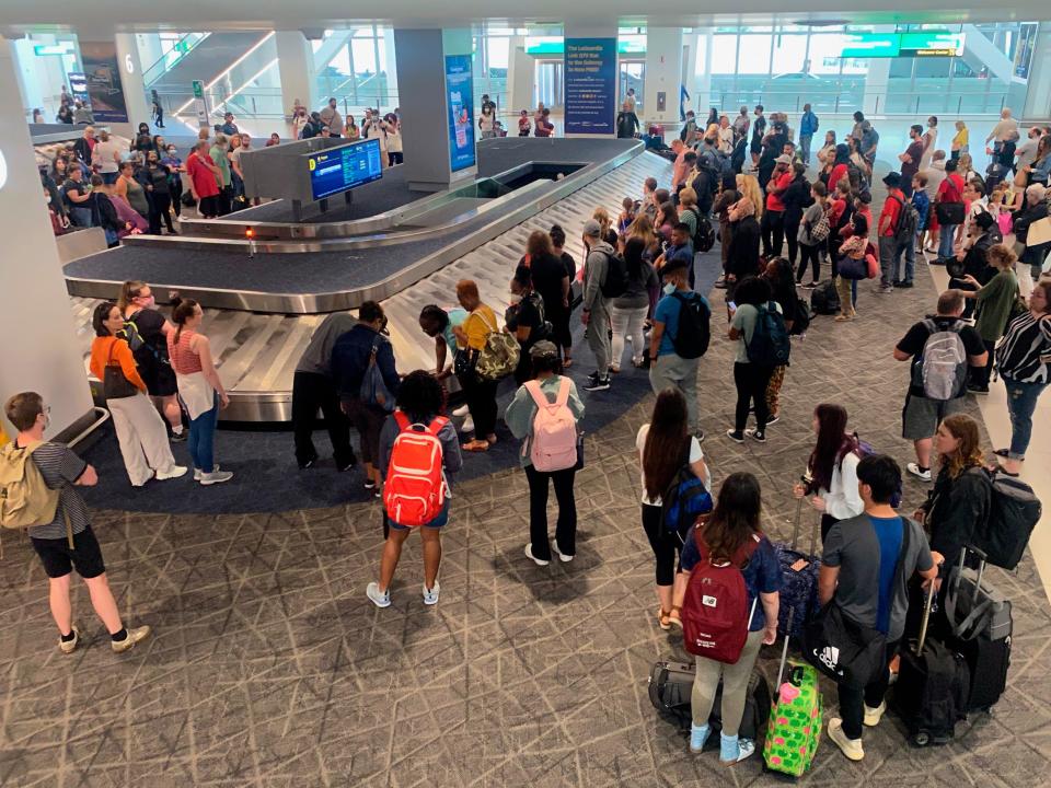 Large crowds of travelers waiting at Baggage claim area, LaGuardia Airport, Queens, New York.