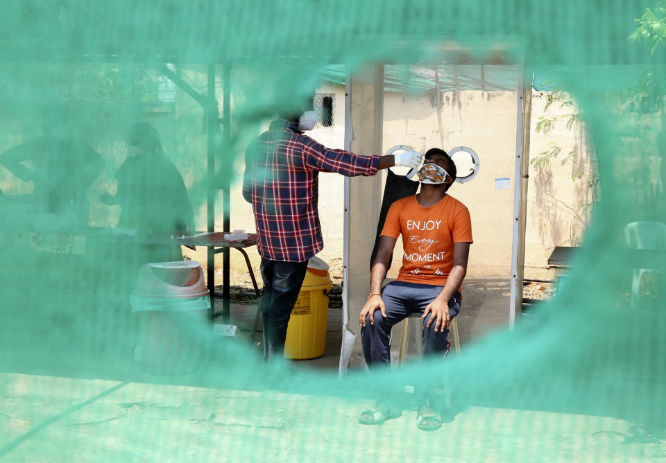 A health worker takes a nasal swab sample to test for COVID-19 in Hyderabad, India, Saturday, April 24, 2021. Indian authorities are scrambling to get medical oxygen to hospitals where COVID-19 patients are suffocating from low supplies. The effort Saturday comes as the country with the world’s worst coronavirus surge set a new global daily record of infections for the third straight day. The 346,786 infections over the past day brought India’s total past 16 million. (AP Photo/Mahesh Kumar A.)