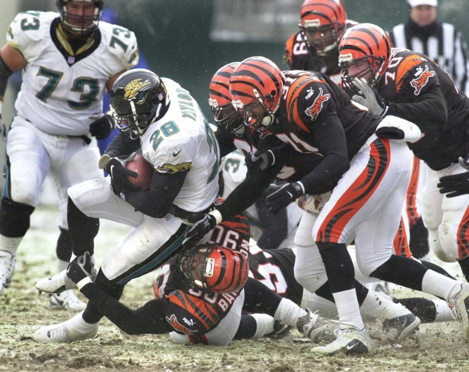 Cincinnati Bengal players converge upon the Jacksonville Jaguars' Fred Taylor during the second quarter Sunday December 17, 2000 at Paul Brown Stadium. Making the tackle is Michael Bankston. Cincinnati Enquirer photo by Gary Landers