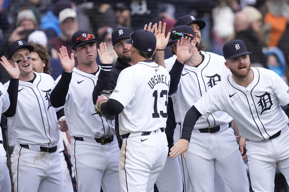 Detroit Tigers third baseman Gio Urshela (13) is greeted by teammates after the ninth inning of a baseball game against the Oakland Athletics, Friday, April 5, 2024, in Detroit. (AP Photo/Carlos Osorio)