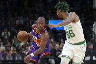 Phoenix Suns guard Chris Paul drives on Boston Celtics guard Marcus Smart (36) during the second half of an NBA basketball game Wednesday, Dec. 7, 2022, in Phoenix. (AP Photo/Rick Scuteri)
