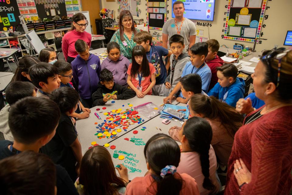 Mrs. Murphy's fourth grade class huddles around a table during a math lesson at Rainbow Valley Elementary School in Buckeye on Tuesday, April 4, 2023.