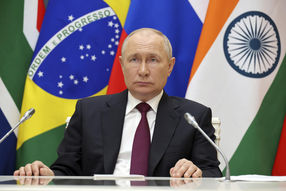 Russian President Vladimir Putin listens to leaders from the BRICS group of emerging economies at the start of a three-day summit in Johannesburg, South Africa via videoconference from Moscow, Russia, Wednesday, Aug. 23, 2023. Putin appeared on a video link after his travel to South Africa was complicated by an International Criminal Court arrest warrant against him over the war in Ukraine. (Mikhail Klimentyev, Sputnik, Kremlin Pool Photo via AP)