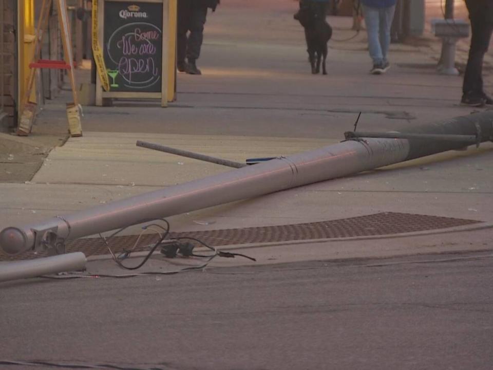 The light pole that struck a pedestrian is shown here on the ground. (CBC - image credit)