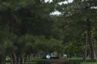 A security stands guard at the central business district in Beijing, China, Monday, July 15, 2024. China's ruling Communist Party is starting a four-day meeting Monday that is expected to lay out a strategy for self-sufficient economic growth in an era of heightened national security concerns and restrictions on access to American technology. (AP Photo/Vincent Thian)