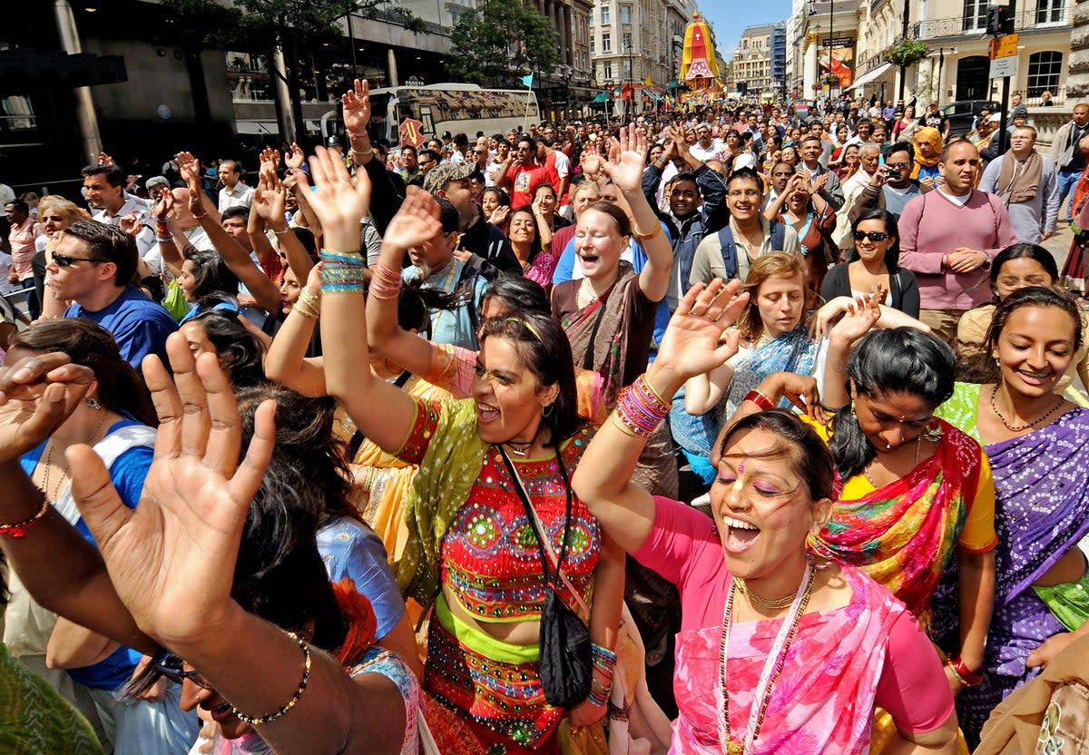 Worshippers take part in the 40th Rathayatra festival in central London where three 40-foot high brightly coloured wooden chariots are pulled by hand from Hyde Park to Trafalgar Square (PA)