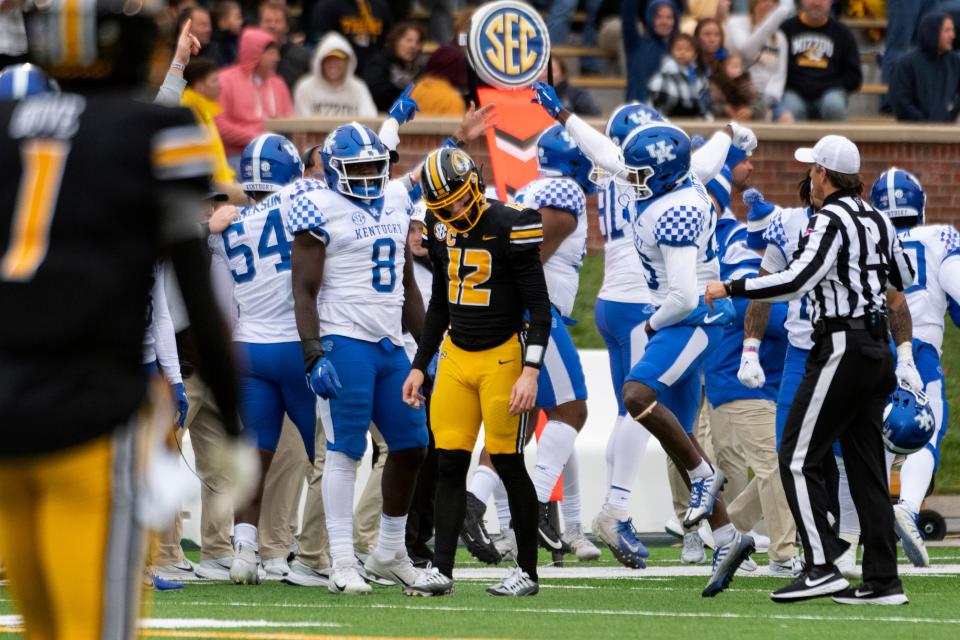 Kentucky teammates celebrate after they recovered a fumble by Missouri quarterback Brady Cook, center, during the second quarter of an NCAA college football game Saturday, Nov. 5, 2022, in Columbia, Mo. (AP Photo/L.G. Patterson)