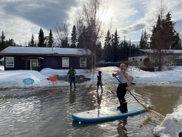 Some Whitehorse residents made the most of the spring melt on their street this week. Emergency officials in Yukon are watching closely for any potential problems associated with flooding this year. (Shawna Kostelnik - image credit)