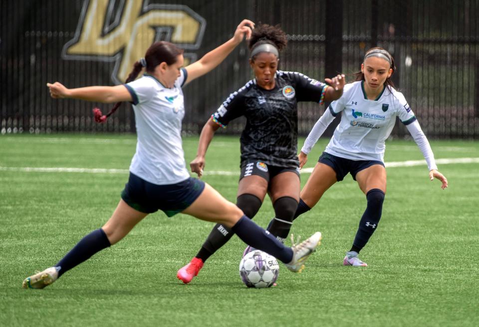 Stockton Cargo's Zusette Rueda Zamora, left, and Yareli Hernandez double team Oakland Soul's Aliyah Jones during the inaugural USL W League game at the San Joaquin Delta College soccer field in Stockton on Saturday, May, 6, 2023.