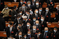 Delegates wearing face masks to protect against the spread of the new coronavirus leave after the opening session of the Chinese People's Political Consultative Conference (CPPCC) at the Great Hall of the People in Beijing, Thursday, May 21, 2020. (AP Photo/Andy Wong, Pool)