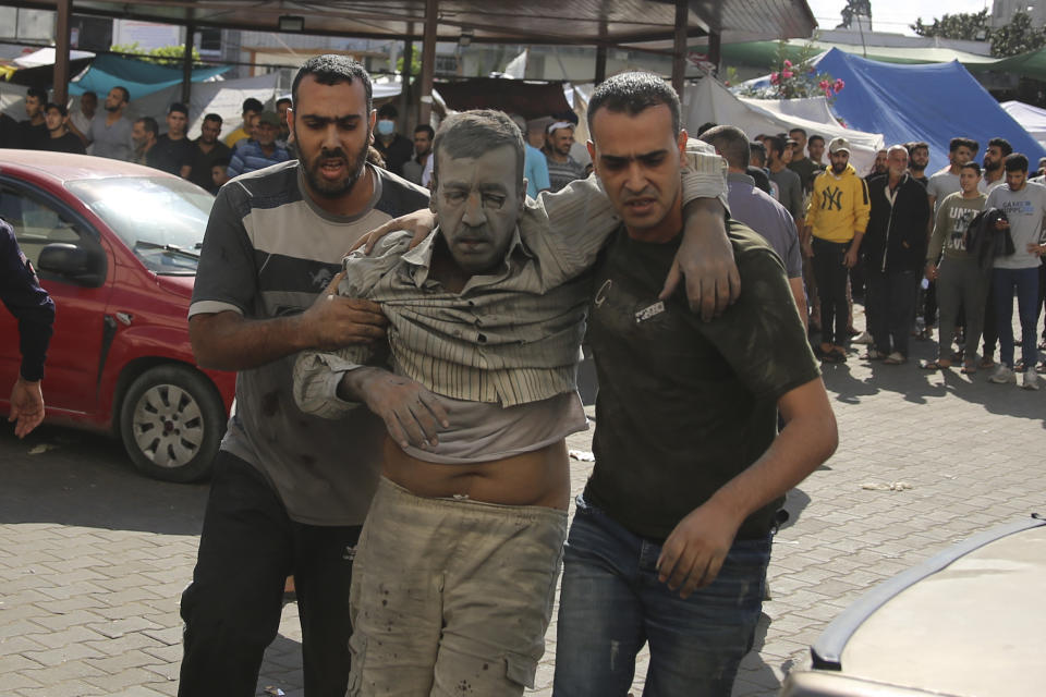 Palestinians bring wounded in Israeli airstrikes to the Shifa hospital in Gaza City, Gaza Strip, Wednesday, Oct. 18, 2023. (AP Photo/Ali Mahmoud)