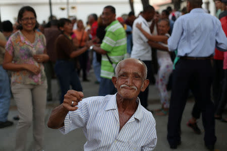 Carmelo Gonzalez dances salsa at El Venezolano square where he meets a seniors club every Friday, Saturday and Sunday afternoon in Caracas, Venezuela, March 22, 2019. Gonzalez said, "I have fun and I work. The pension helps me a bit. You have to enjoy life, after you die there is nothing else." REUTERS/Ivan Alvarado