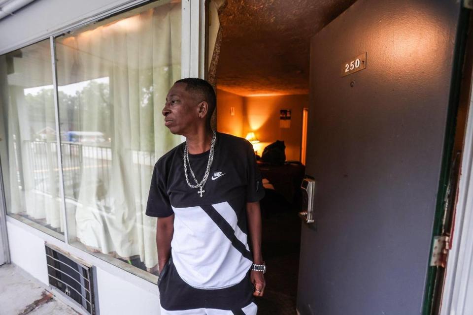 Sasha Vernon stands outside the room she shares with her friend, Brian Falls, at Southern Comfort Inn on Monday, June 27, 2022 in Charlotte, NC. Vernon is trying to help Falls find an affordable apartment instead of a room at another hotel, which would likely be a temporary solution.