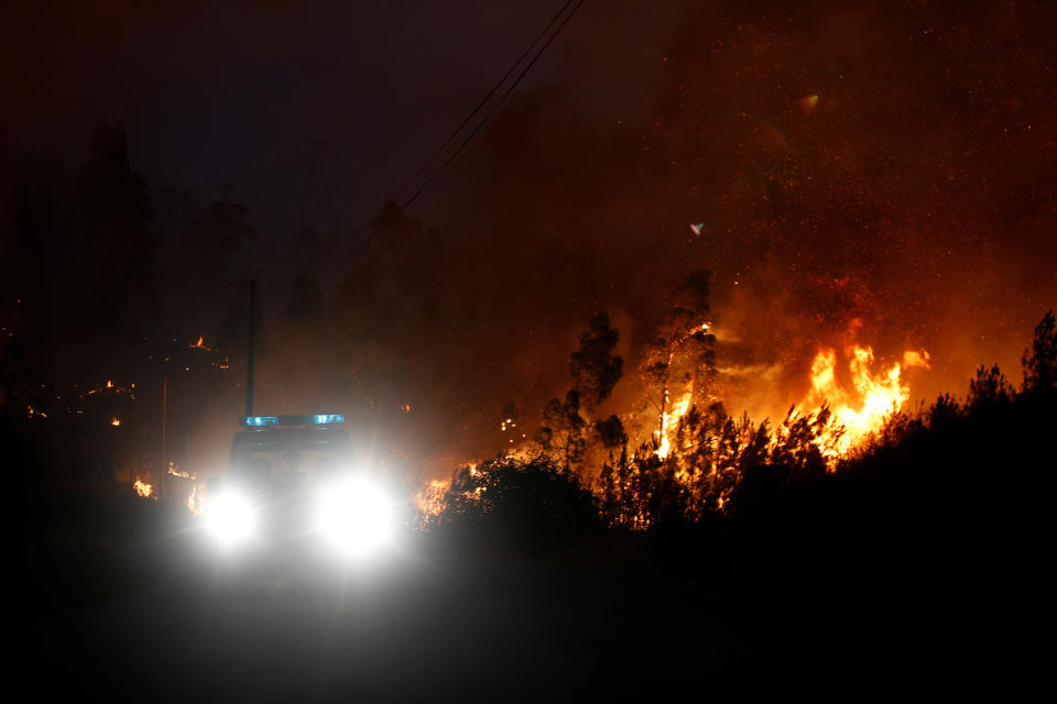 <p>Firefighters work to put out a forest fire next to the village of Macao, near Castelo Branco, Portugal, July 26, 2017. (Rafael Marchante/Reuters) </p>